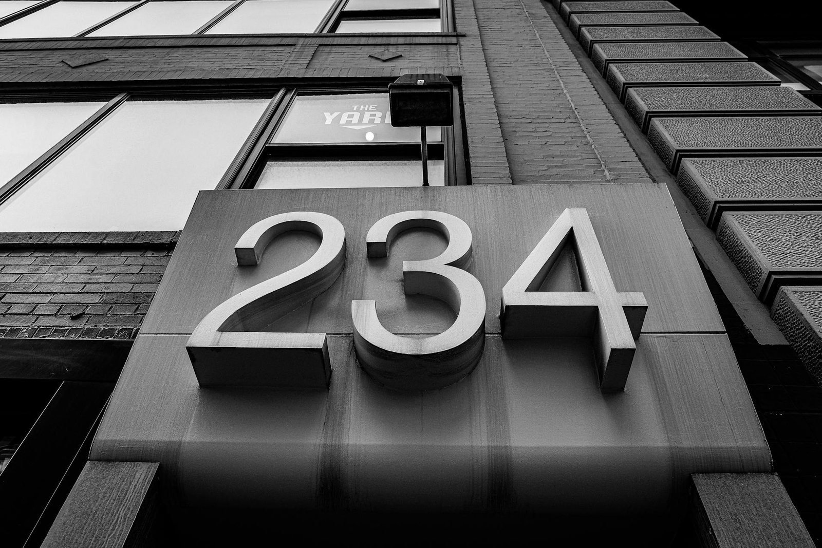 Physical business address - Photo by Vitaly Kushnir: https://www.pexels.com/photo/grayscale-photo-of-a-house-number-10895214/